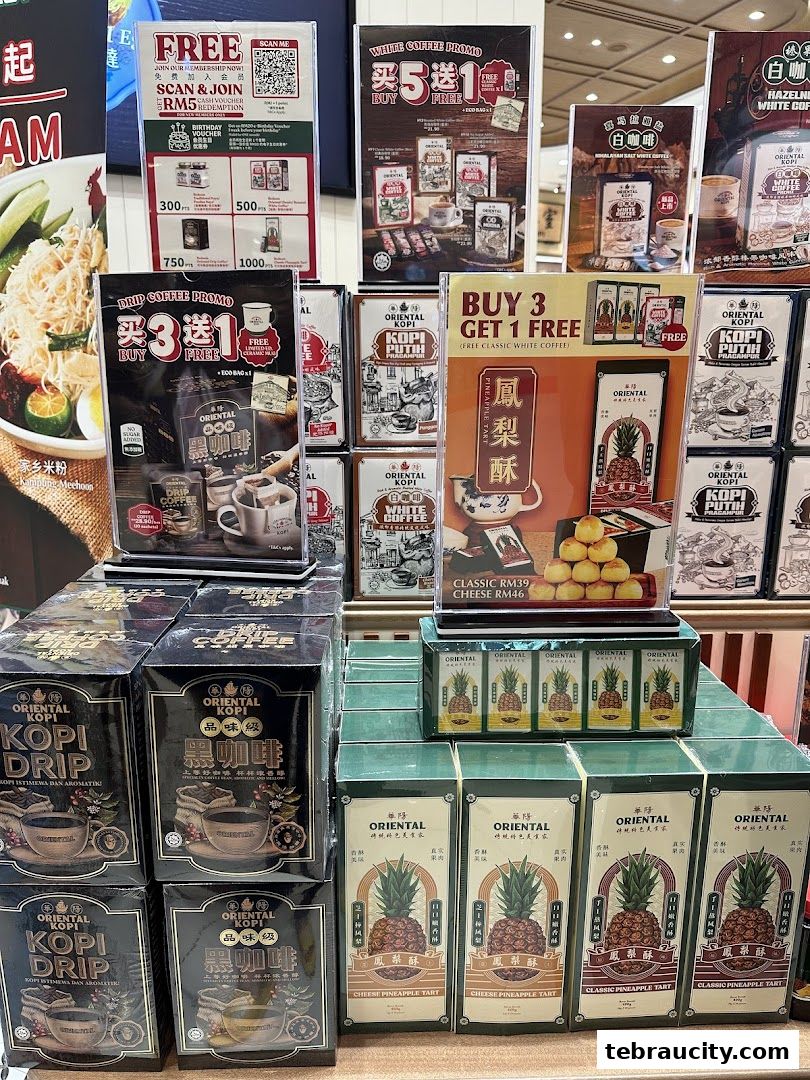 A display of Oriental Kopi products including drip coffee and pineapple tarts with promotional signage.