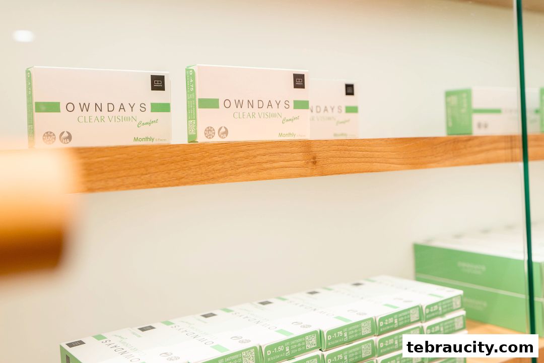Boxes of OWNDAYS contact lenses displayed on shelves in a retail store.