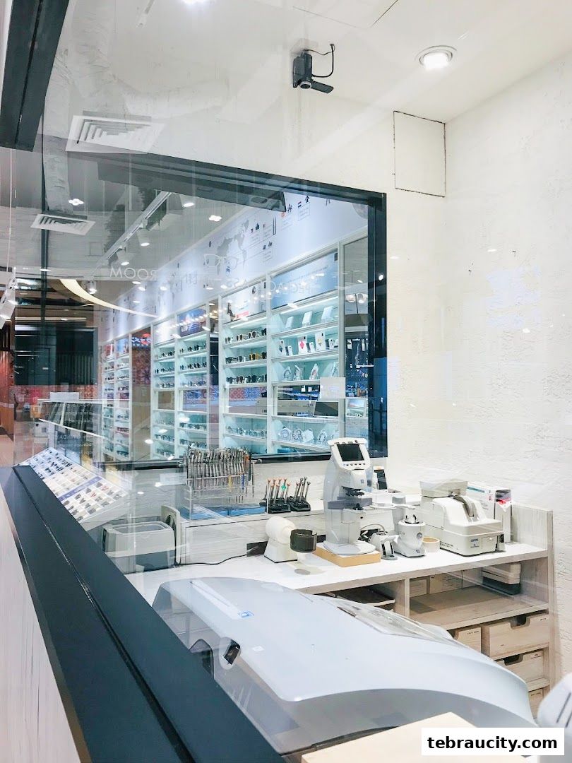 Interior view of an optical shop with display shelves and optical equipment.