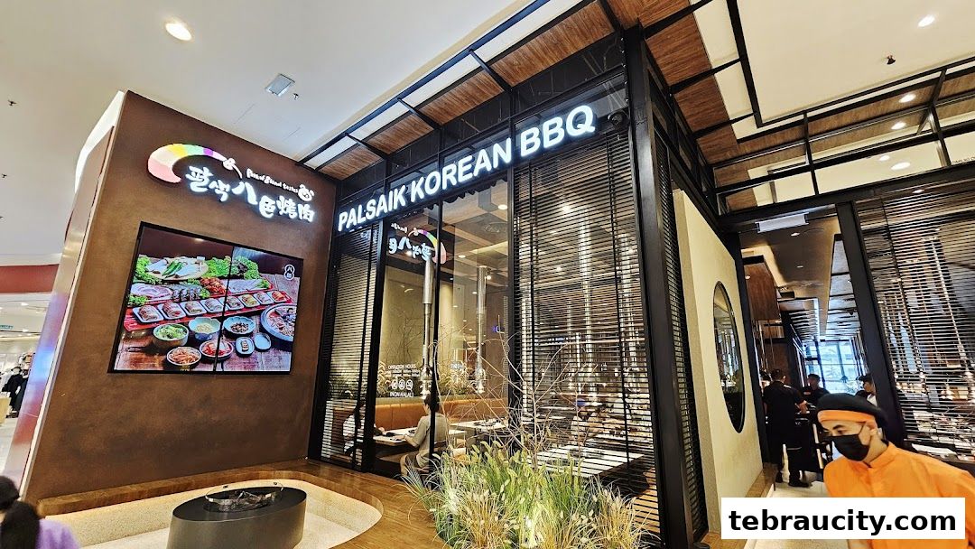 The exterior of Palsaik Korean BBQ restaurant with a large digital display showcasing food.