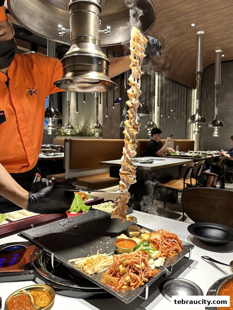 A chef grills marinated pork belly at a Korean BBQ restaurant.