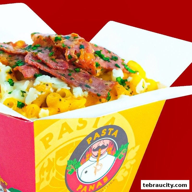 A close-up shot of a delicious pasta dish served in a branded takeaway box.