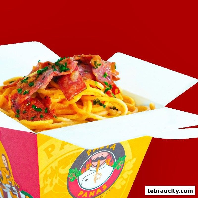 A close-up shot of pasta with bacon and herbs in a takeaway box.