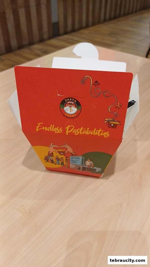A red takeout box from Pasta Panas with the slogan 'Endless Pastabilities' and cartoon illustrations.