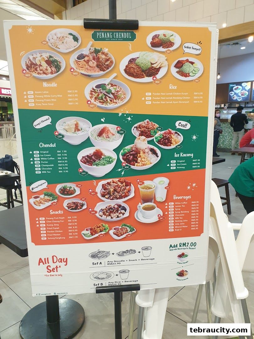 A menu board displaying various Penang Chendul dishes, noodles, rice, snacks, beverages, and set meals.