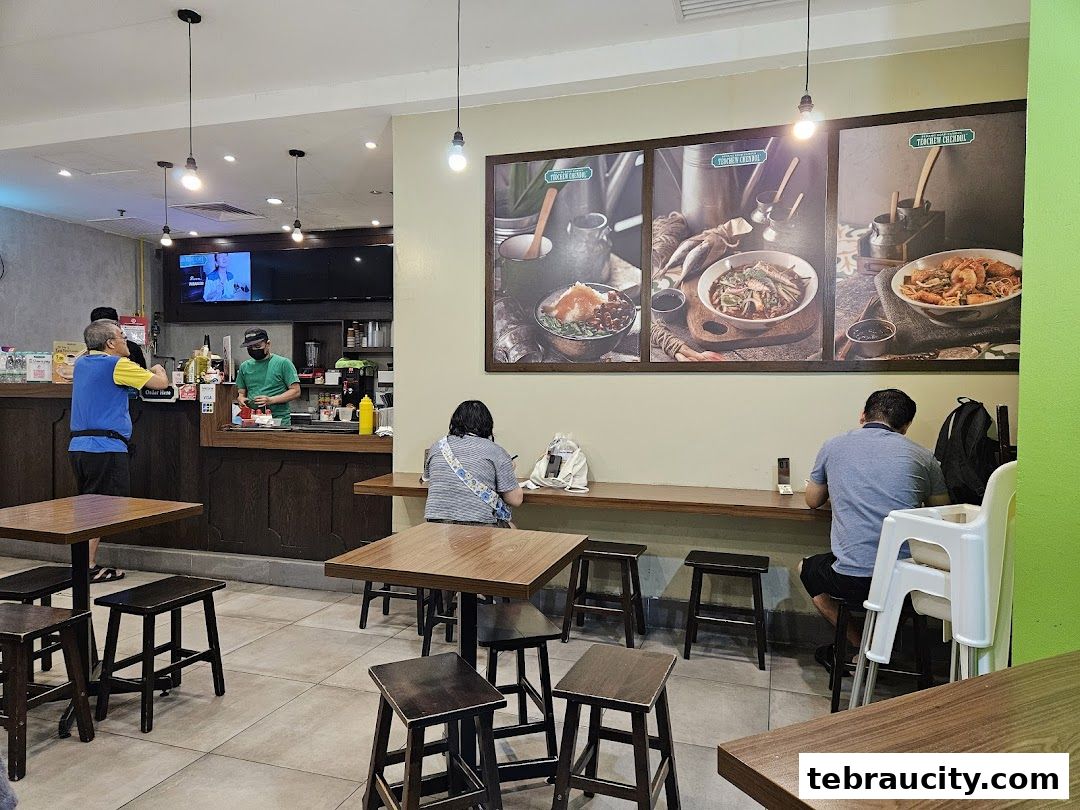 Interior of a casual eatery with customers seated and staff behind the counter.