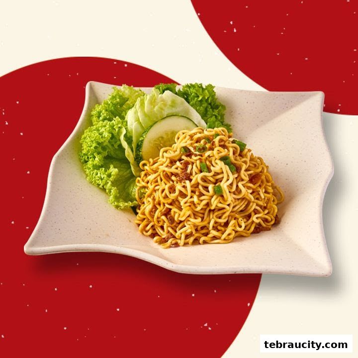 A plate of savory noodles with fresh lettuce and cucumber slices.