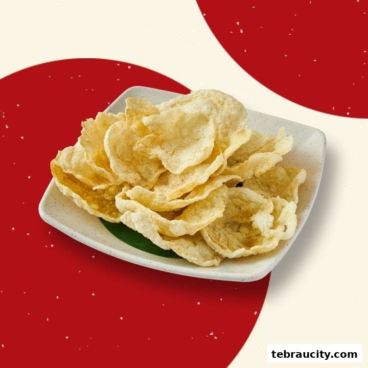 A plate of crispy, golden-brown crackers served on a white plate with a green leaf.