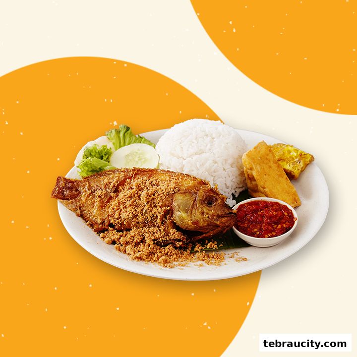 A plate of crispy fried fish with rice, tempeh, and sambal.