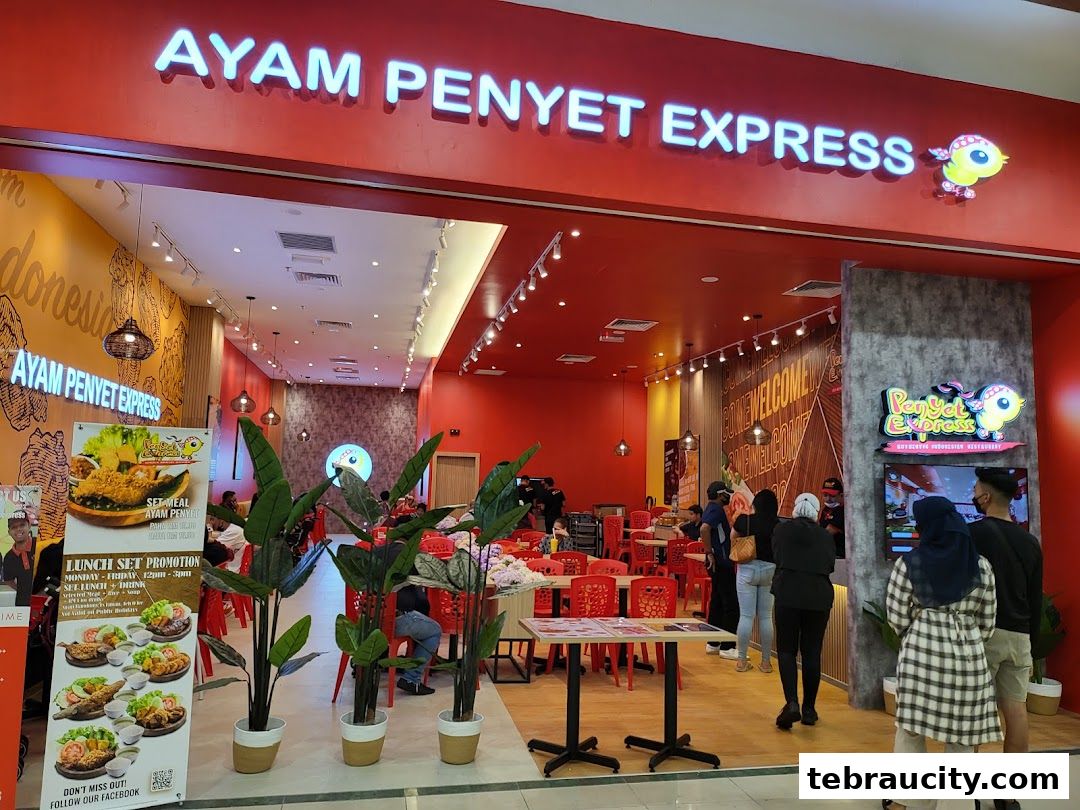 The entrance of Ayam Penyet Express, a restaurant with red walls and seating.