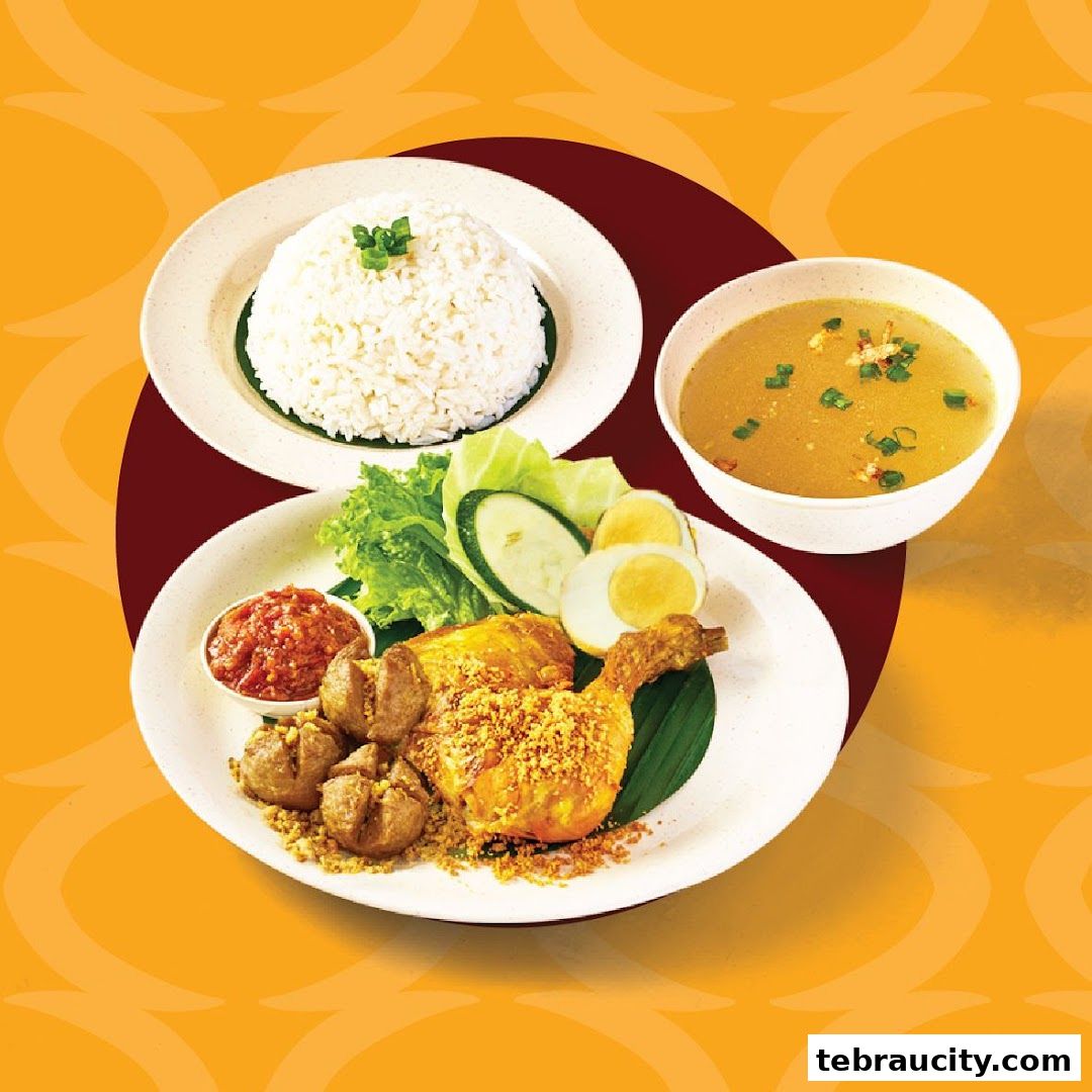 A plate of Indonesian fried chicken with rice, soup, and side dishes.
