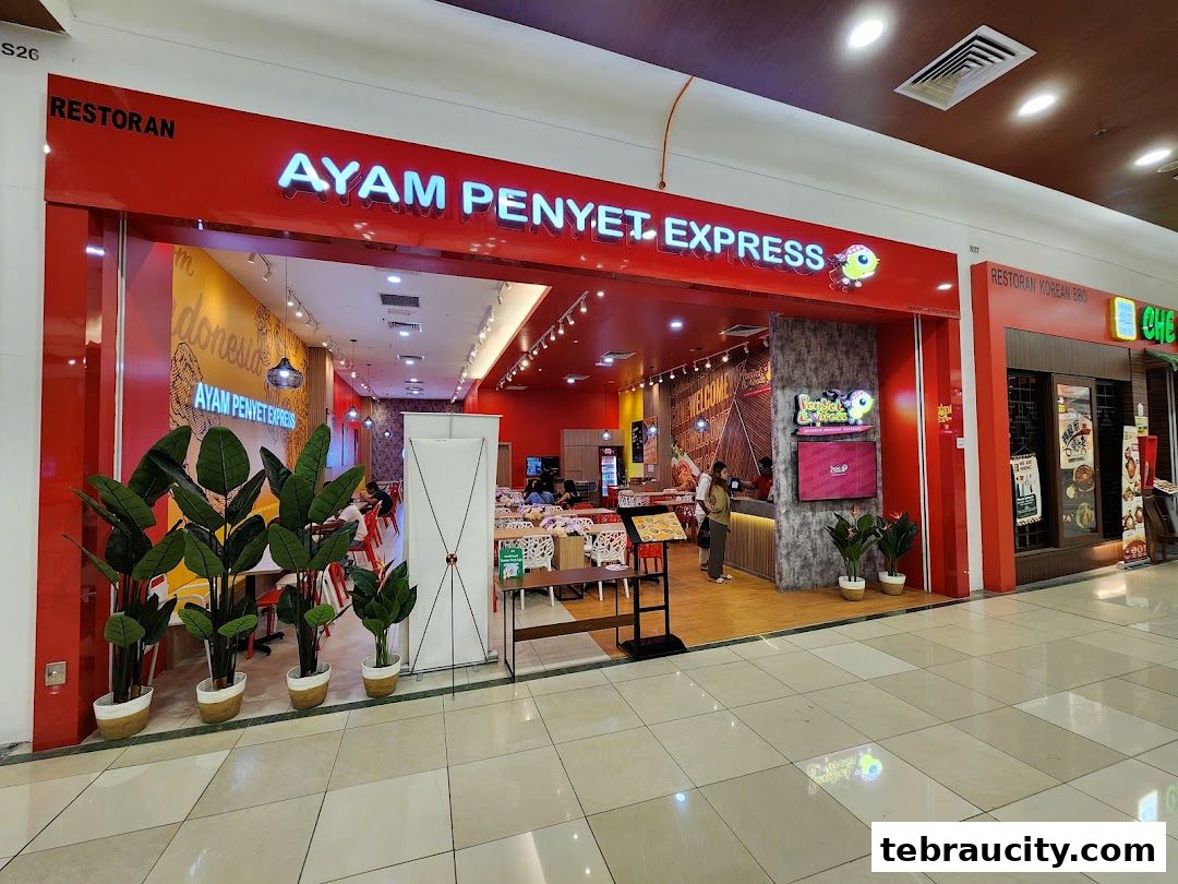 The bright red exterior of Ayam Penyet Express restaurant with its name prominently displayed.