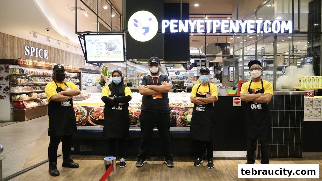 Five staff members in uniform stand in front of the PenyetPenyet store.