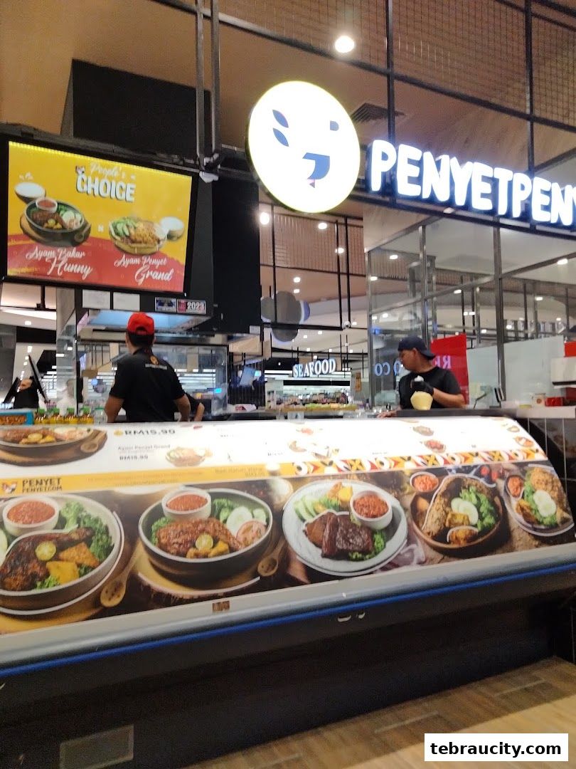 The PenyetPenyet shop front displays a menu with appetizing images of Indonesian cuisine.
