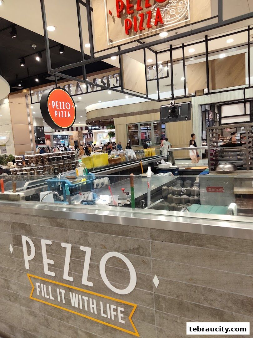 The Pezzo Pizza shop front with its prominent signage and display counter.