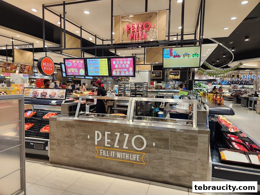 The Pezzo Pizza counter inside a supermarket with various pizza options displayed.