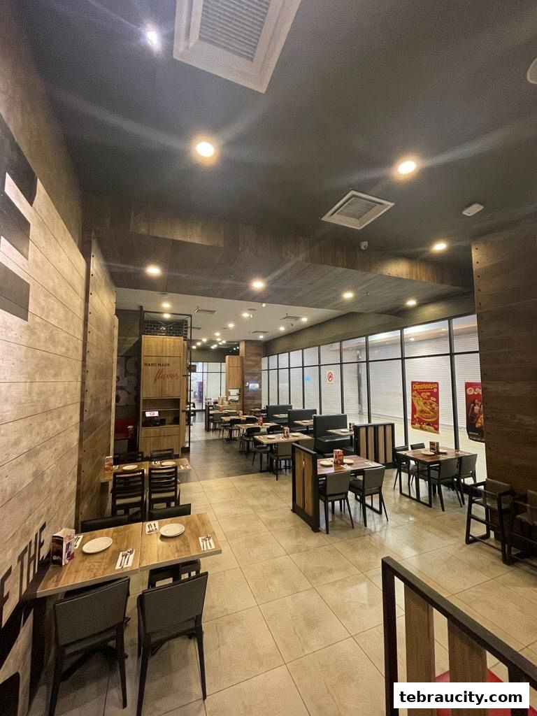 Interior view of a Pizza Hut restaurant with tables and chairs set up for dining.