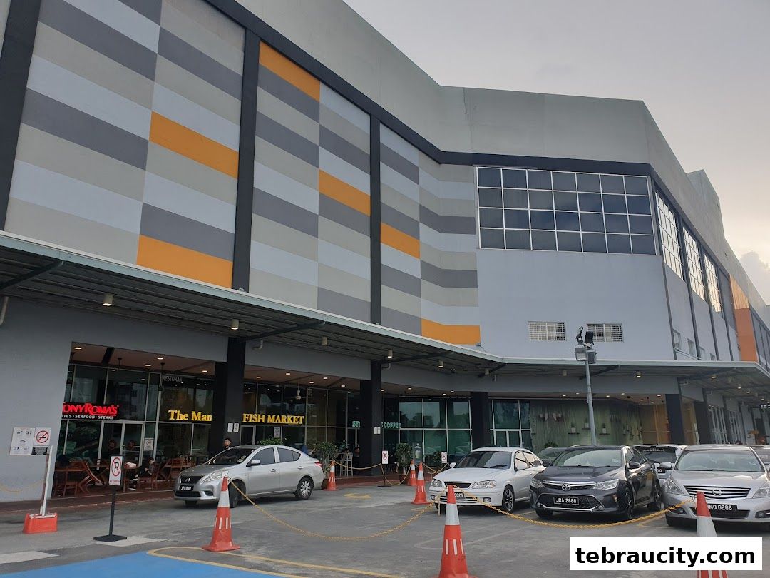 Exterior view of a modern building with multiple shops, including Tony Roma's and Fish Market.