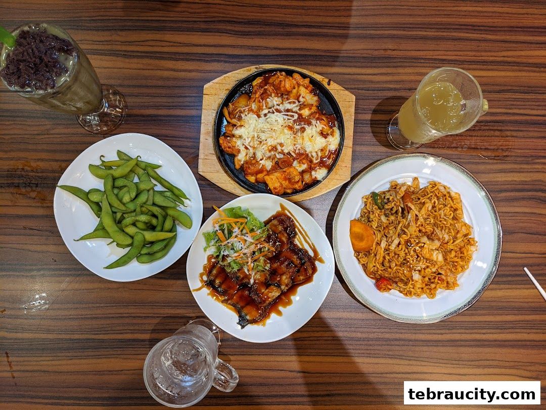 A top-down view of a table with various Korean dishes and drinks.