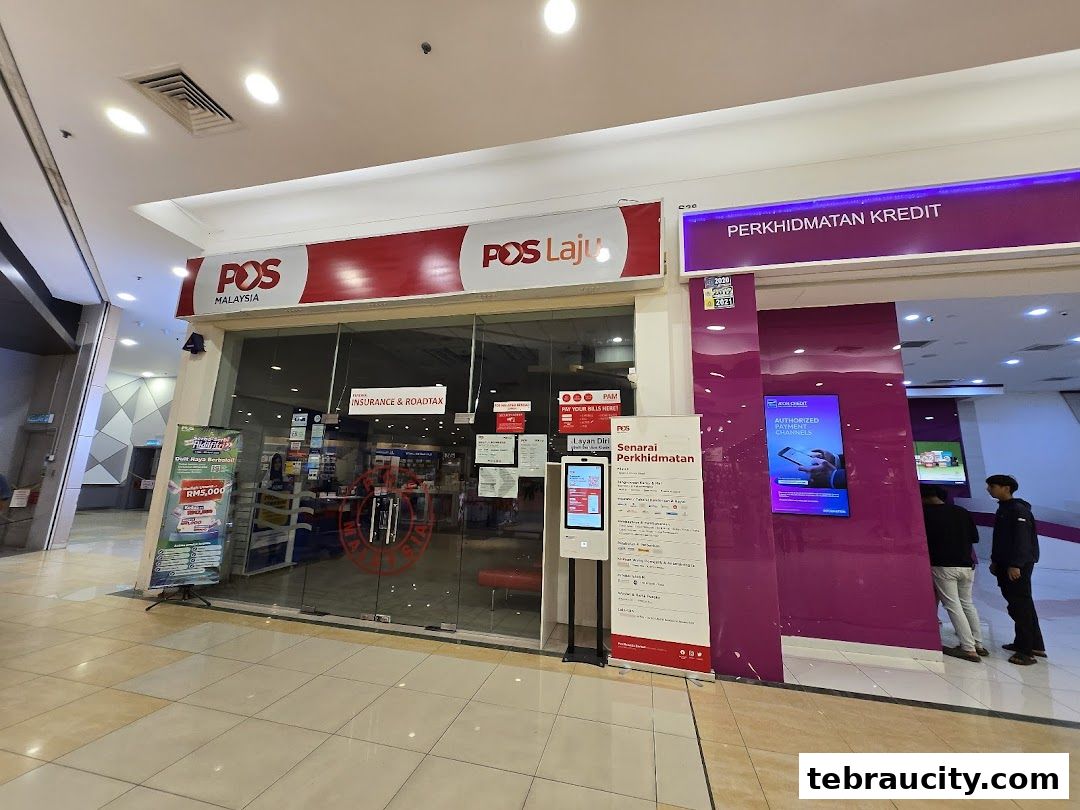 The Pos Malaysia shop front with signage and a digital display showing services.