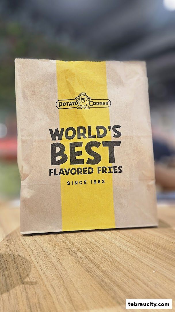 A paper bag from Potato Corner advertising their world's best flavored fries since 1992.