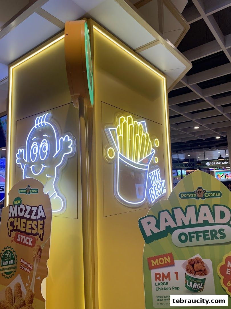 Potato Corner shop with neon signs and promotional posters for Mozza Cheese Stick and Ramadan offers.