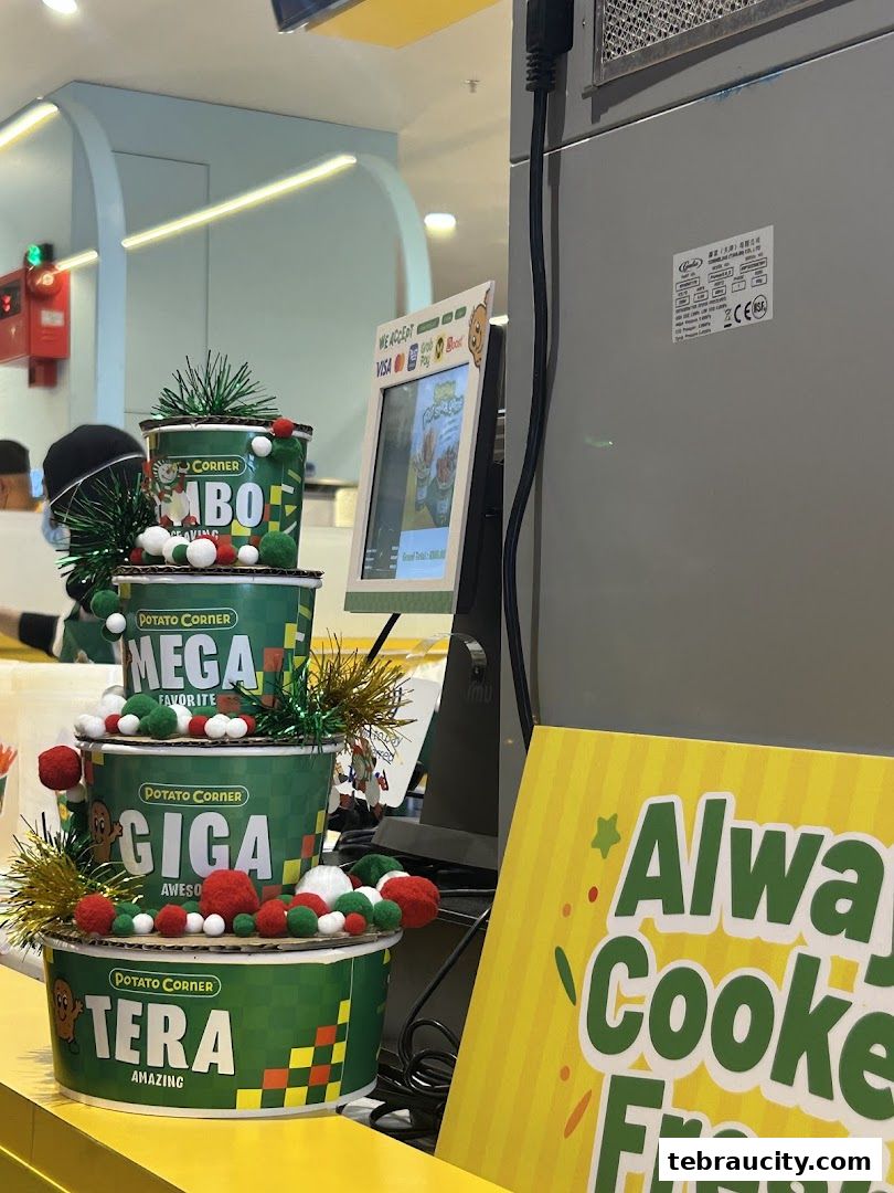 Potato Corner shop display with various sizes of fries and festive decorations.