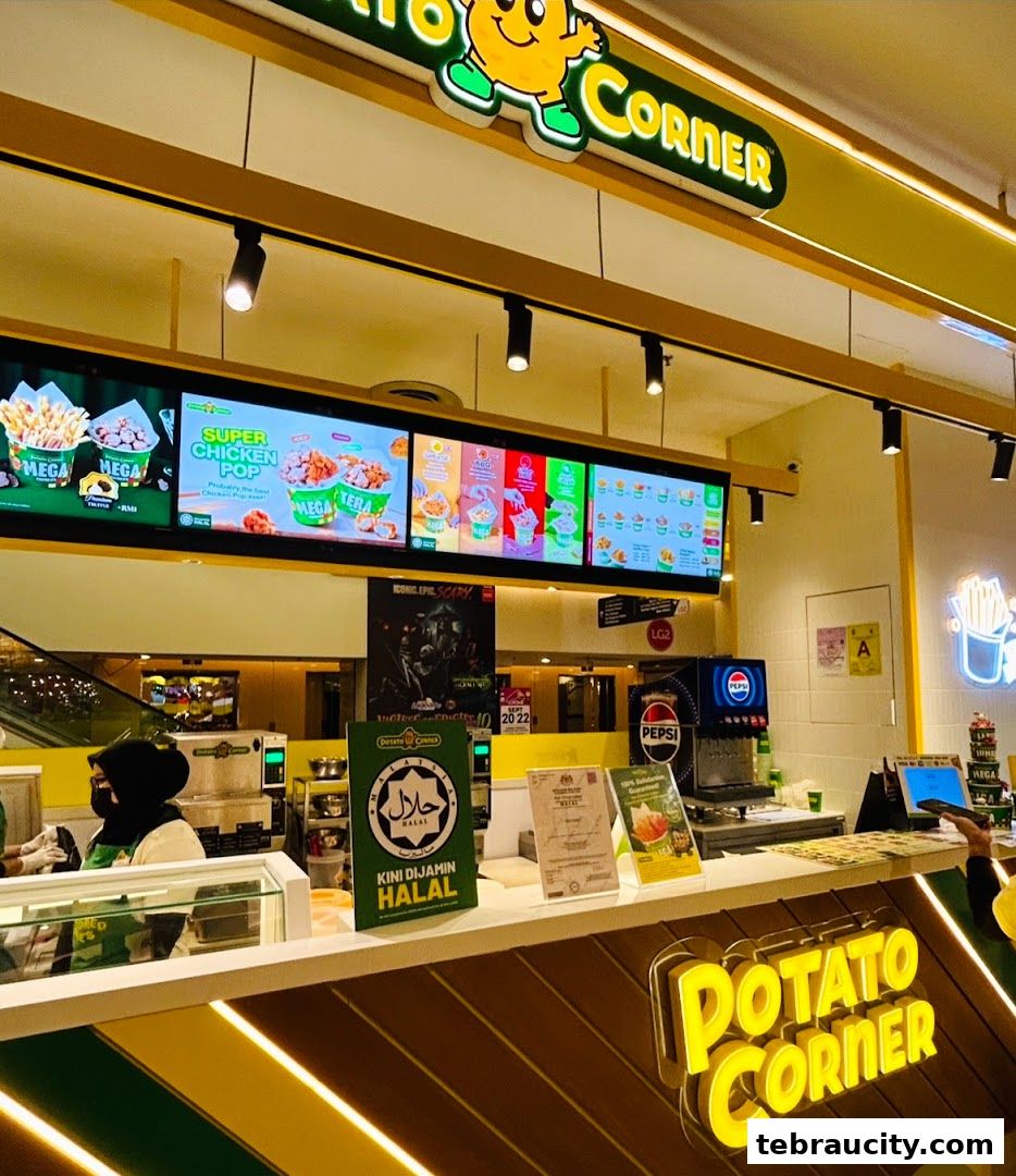 The Potato Corner shop front with digital menus displaying fries and chicken pop.