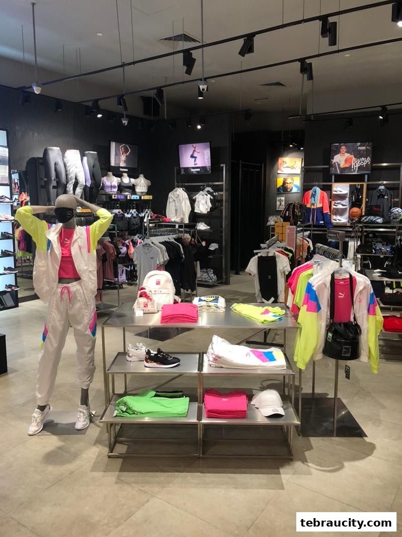 A PUMA store interior showcasing athletic apparel, footwear, and accessories on display.