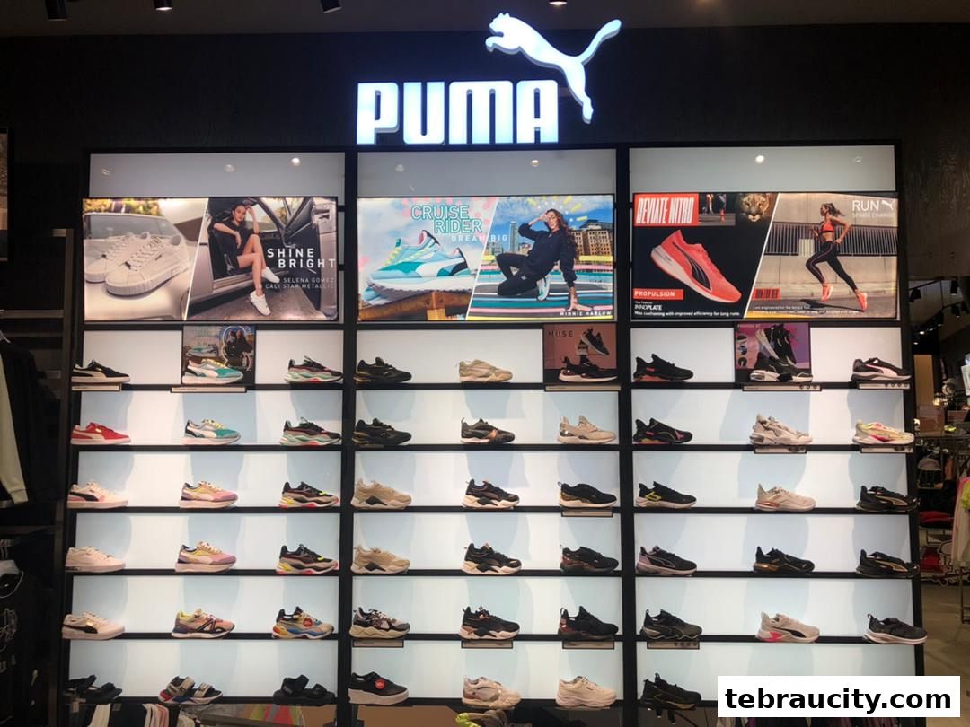 A well-lit PUMA store interior showcasing a wide variety of athletic footwear on display shelves.