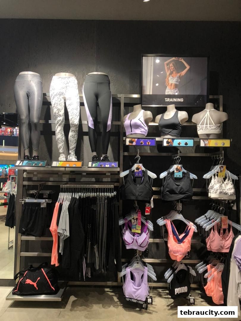 Puma store display featuring mannequins in athletic wear and racks of sportswear.