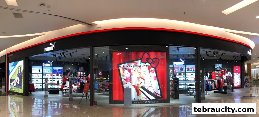 The exterior of a modern Puma store showcasing athletic apparel and footwear, including a Hello Kitty collaboration.
