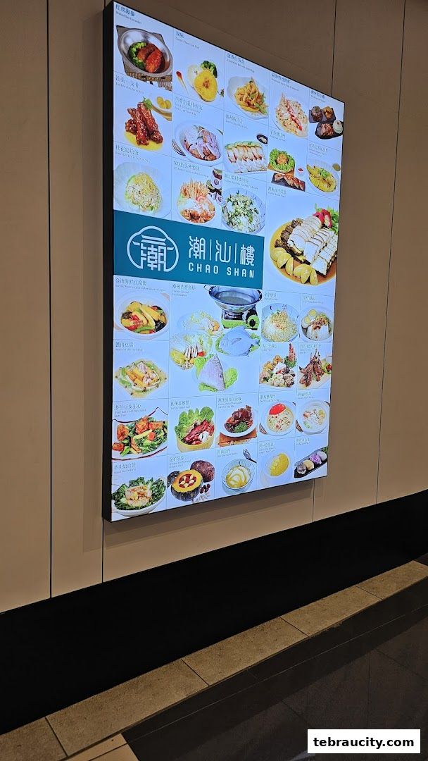 A brightly lit menu board displaying various Chinese dishes with appetizing images.