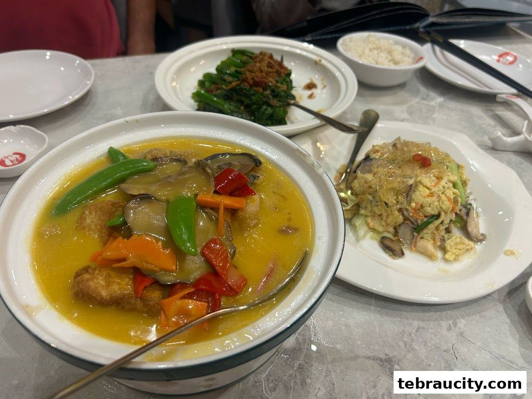 A table laden with delicious Chinese dishes, including a savory stew and stir-fried vegetables.