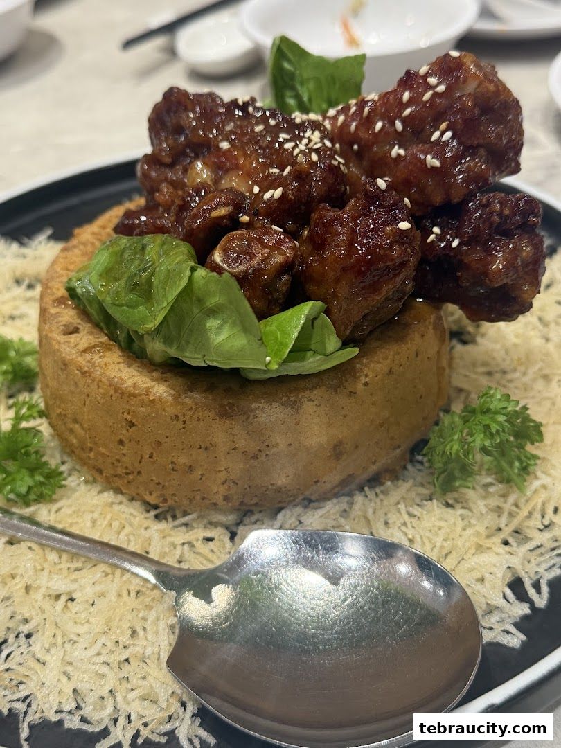 A close-up of a delicious dish with glazed ribs served on a bed of crispy noodles.