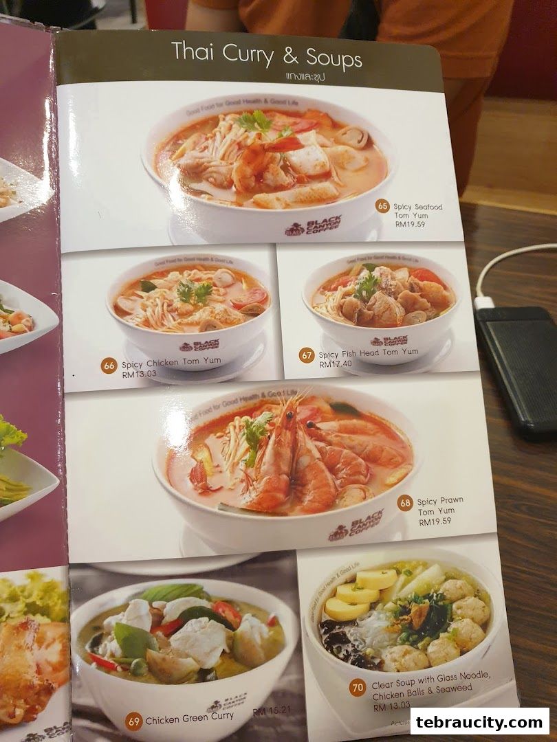 A menu page showcasing Thai curries and soups with appetizing food photography.