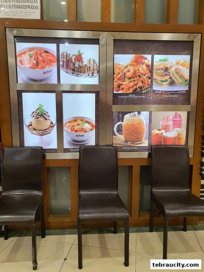 A display of food and drinks from Restoran Black Canyon with chairs in front.