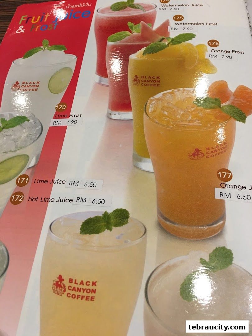 A menu page showcasing various fruit juices and frosty drinks from Black Canyon Coffee.