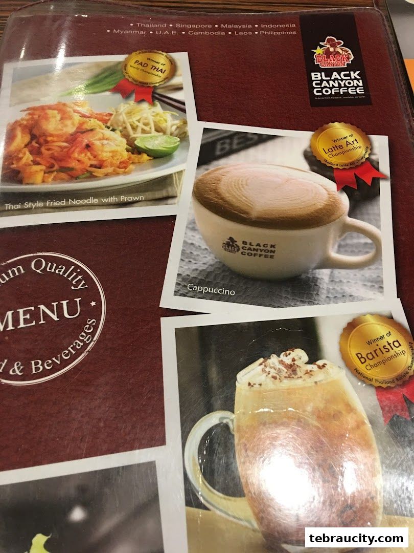 A menu from Black Canyon Coffee featuring Pad Thai, Cappuccino, and other beverages.