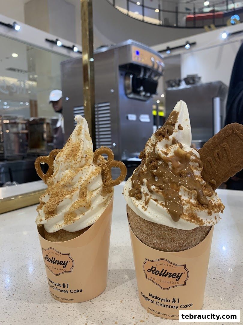 Two delicious chimney cakes with soft serve ice cream and toppings at Rollney.