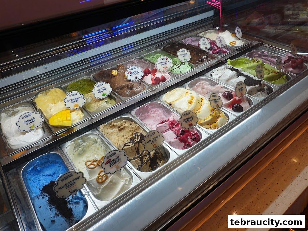 A display case filled with various flavors of ice cream, labeled with names.
