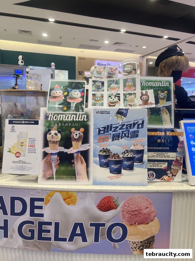 A display counter at Romanlin ice cream and tea, showcasing various ice cream cones and Blizzard cups.