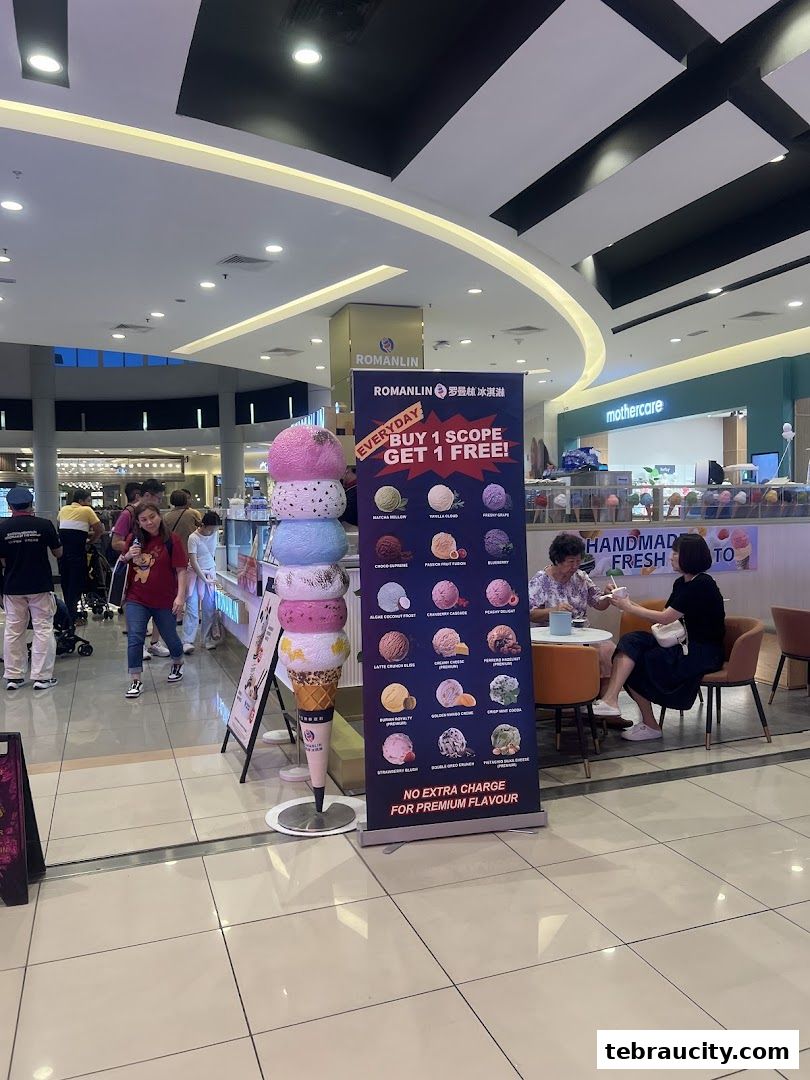 A Romanlin ice cream and tea shop with a large ice cream cone display and a promotional banner.