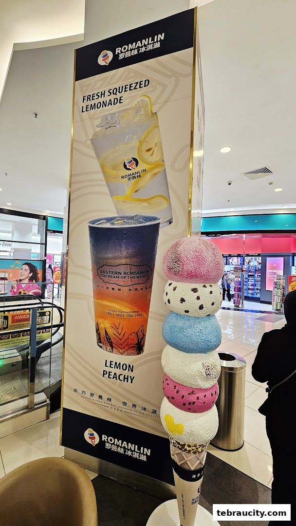 A large advertisement for Romanlin ice cream and tea featuring drinks and an ice cream cone sculpture.