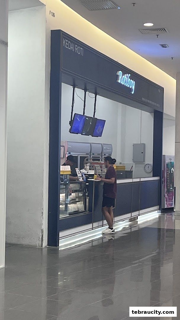A Rotiboy shop with staff serving customers inside.