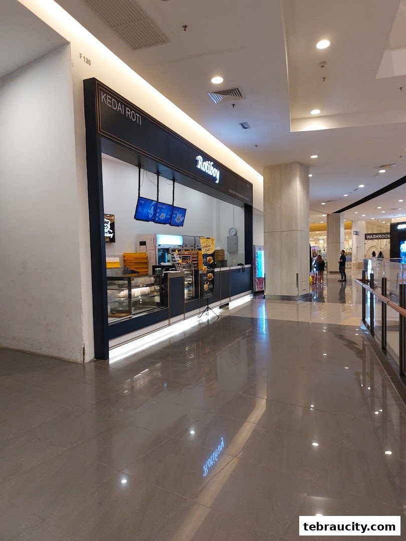 The Roti Boy shop front in a mall, showcasing baked goods and a clean, modern design.