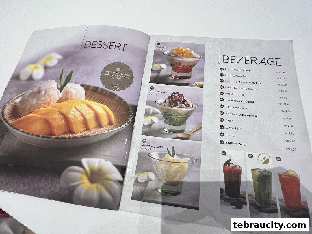 A menu featuring Thai desserts like mango sticky rice and beverages.