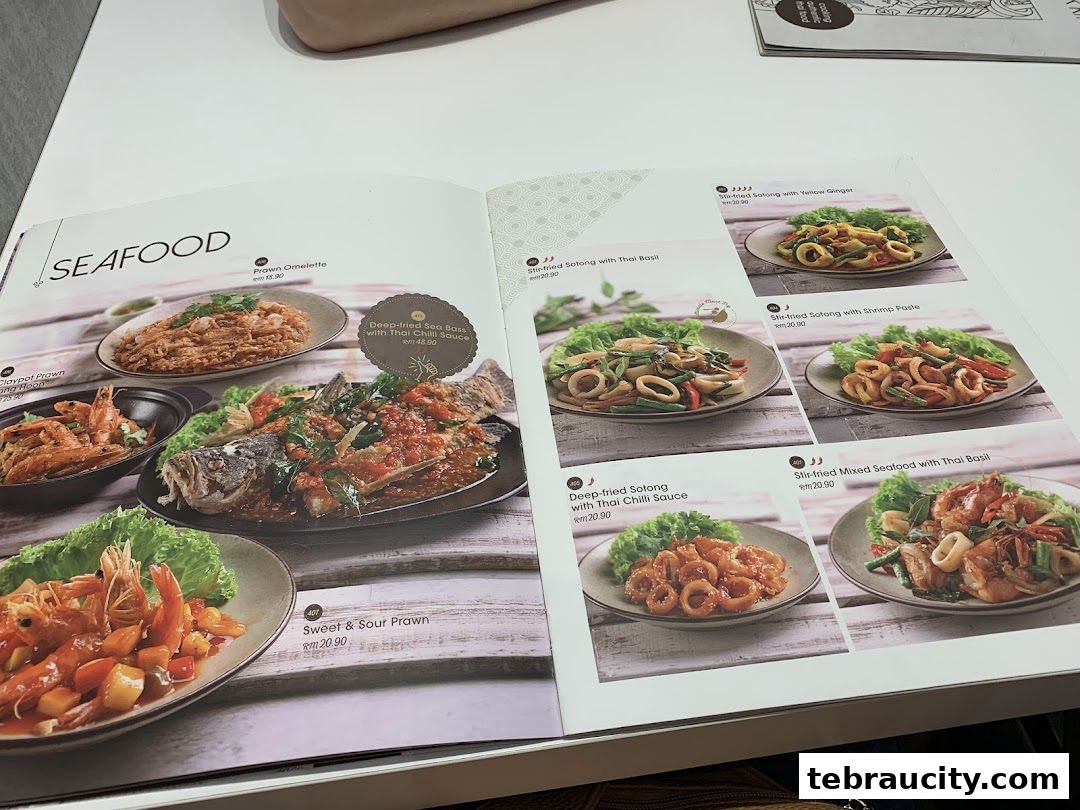 A menu from Sanook Kitchen featuring various seafood dishes with appetizing images.