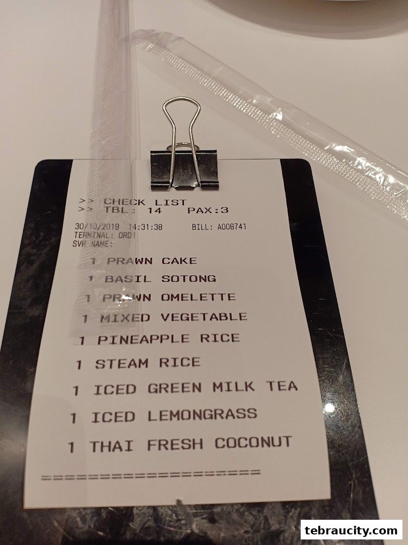 A close-up of a restaurant check list with food and drink items ordered.