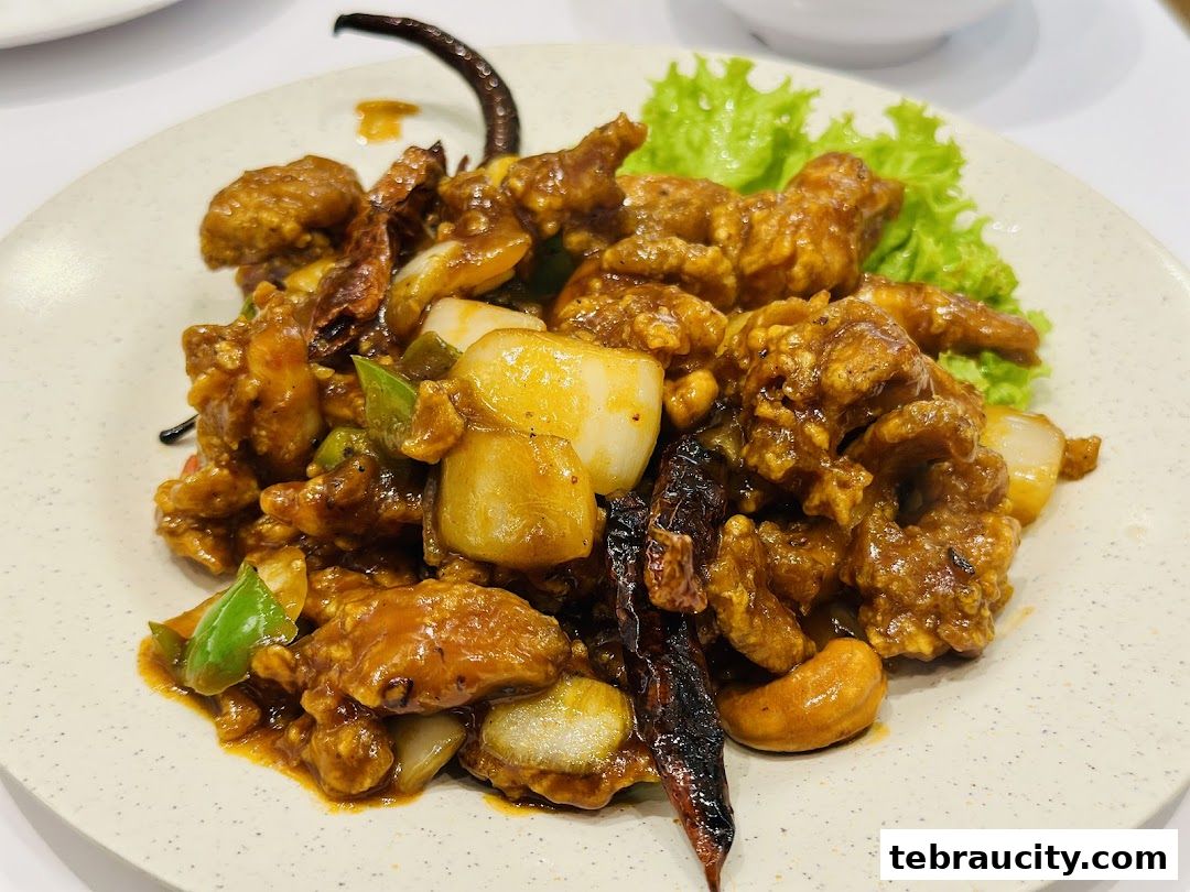 A plate of delicious stir-fried chicken with cashews, peppers, and dried chilies.